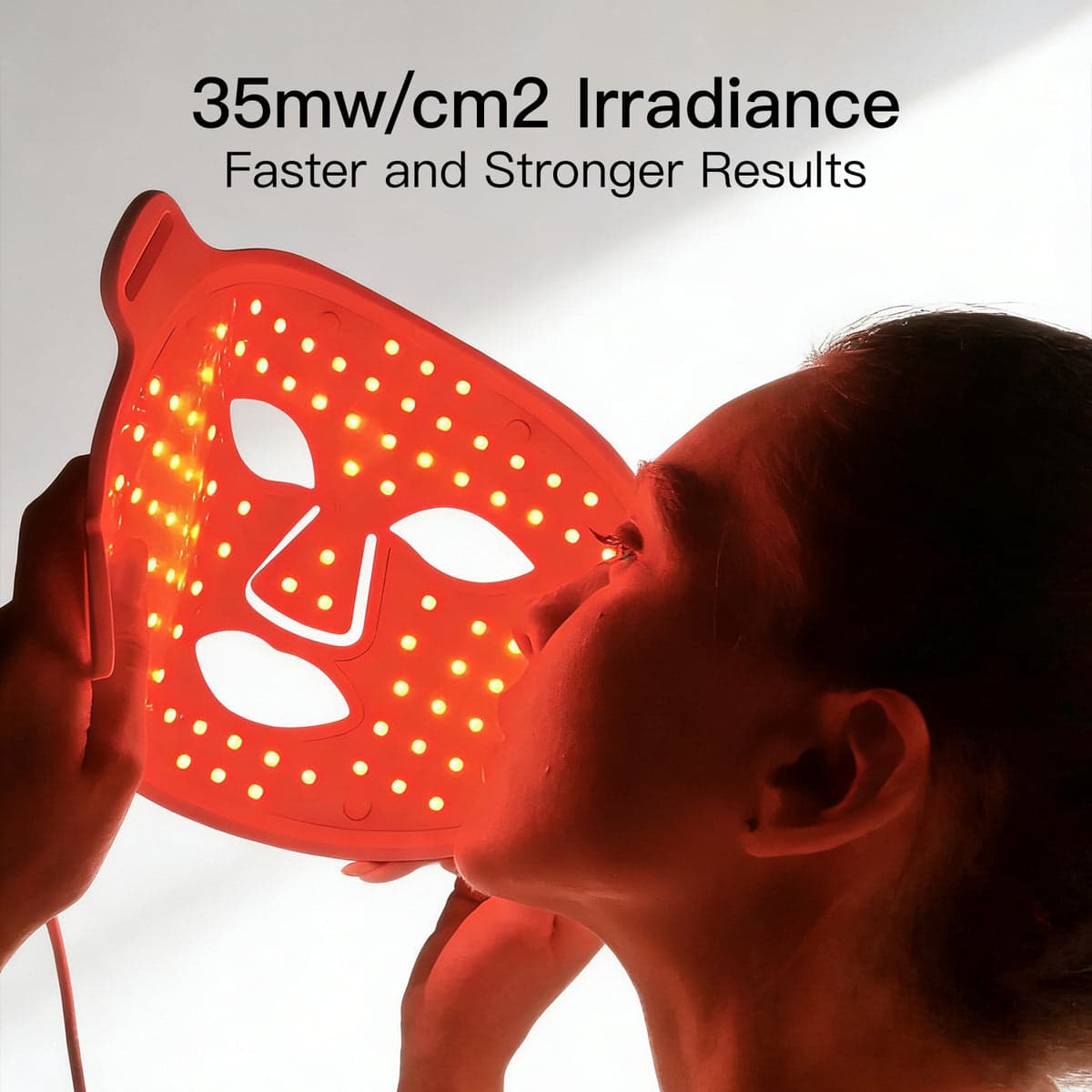 The Megelin LED face mask illuminated, showing the flexible silicone panel and LED array